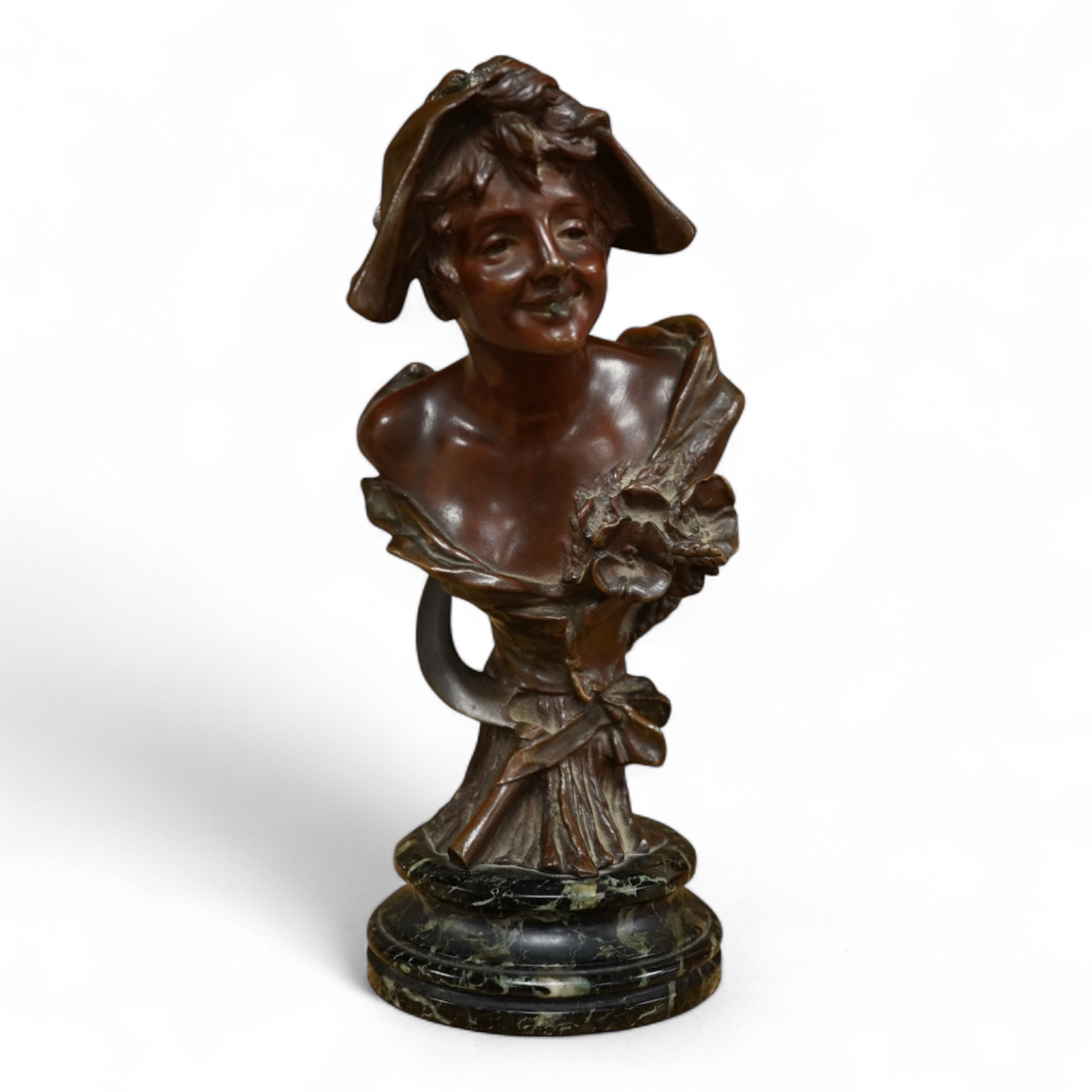 A late 19th century bronze bust of a lady in a hat with floral decoration , mounted on marble, signed, 21.5cm high.